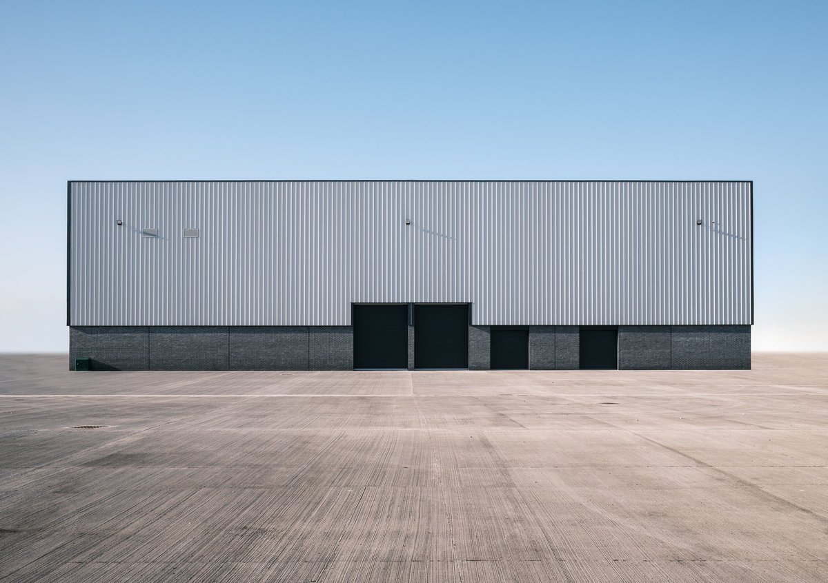 Large empty distribution warehouse or fulfillment centre with high ceilings — MAY Engineering industrial engineering Ontario