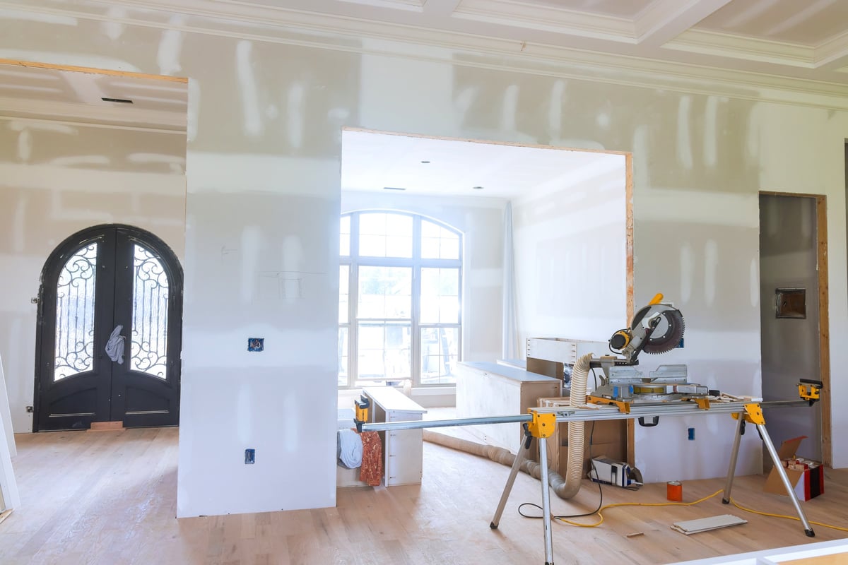 Modern living space during a home renovation with tools and unfinished walls
