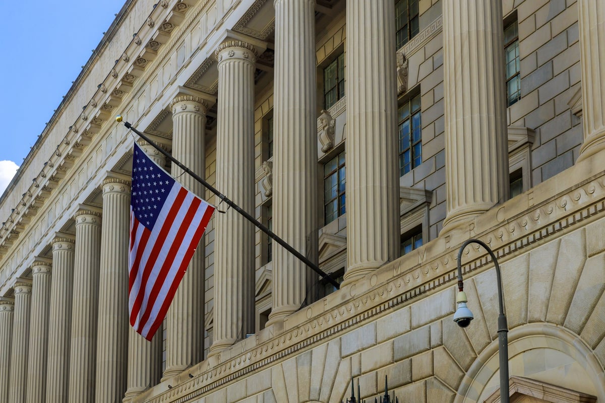 Historic government building with architectural facade and waving flag — MAY Engineering institutional engineering Ontario