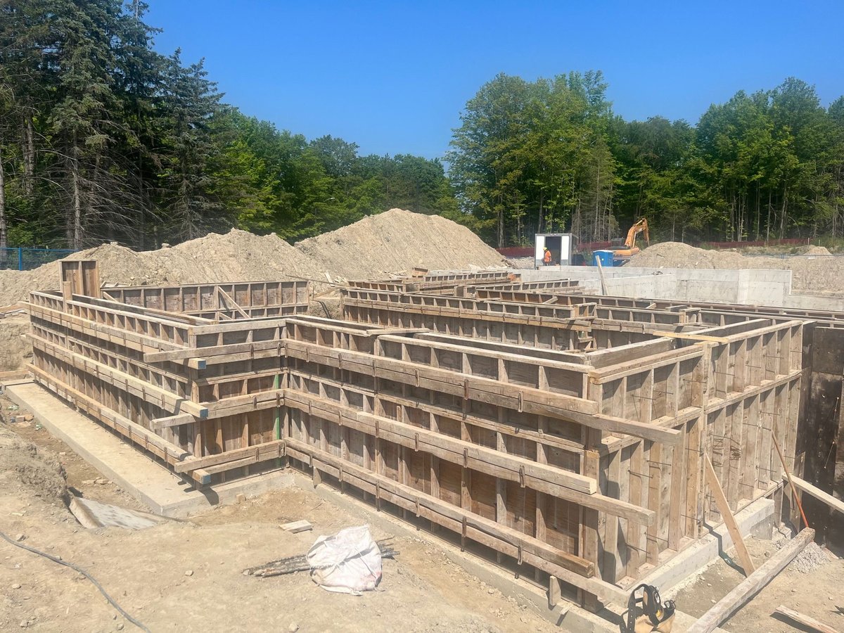 Wooden foundation framework of a house under construction on sandy lot — permit drawings residential addition project in Toronto Ontario — MAY Engineering Inc.