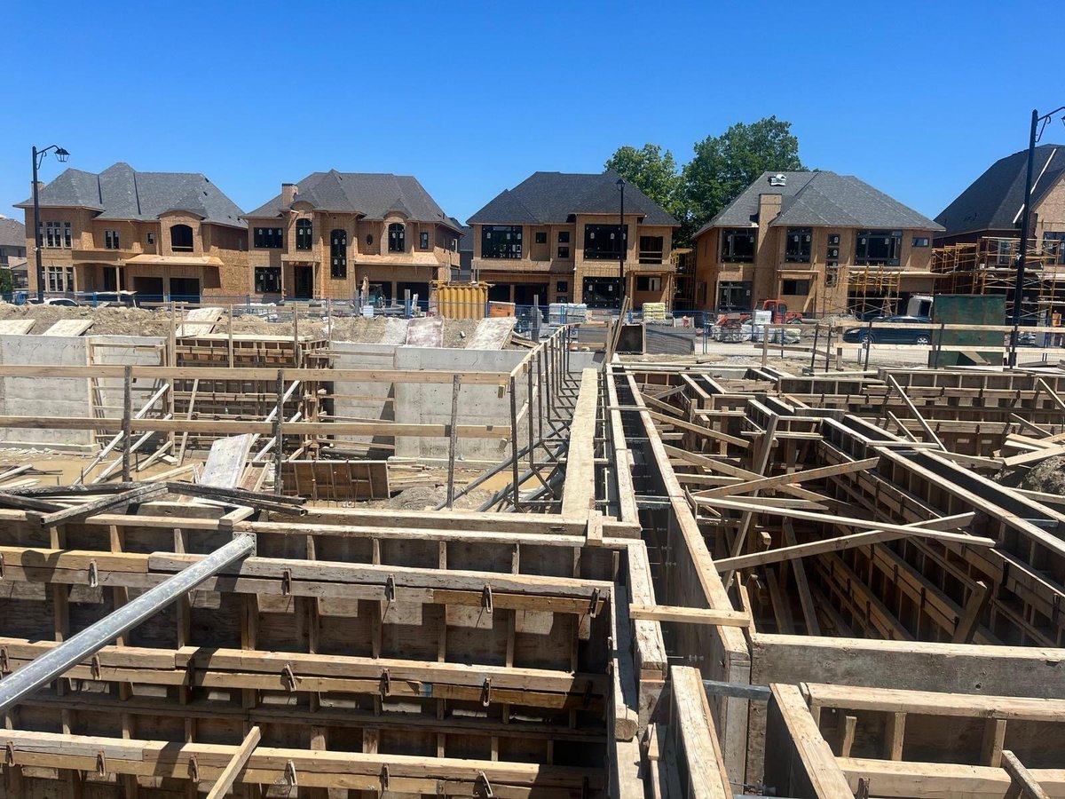 Residential construction site with multiple large homes under construction — MAY Engineering team Ontario project plans