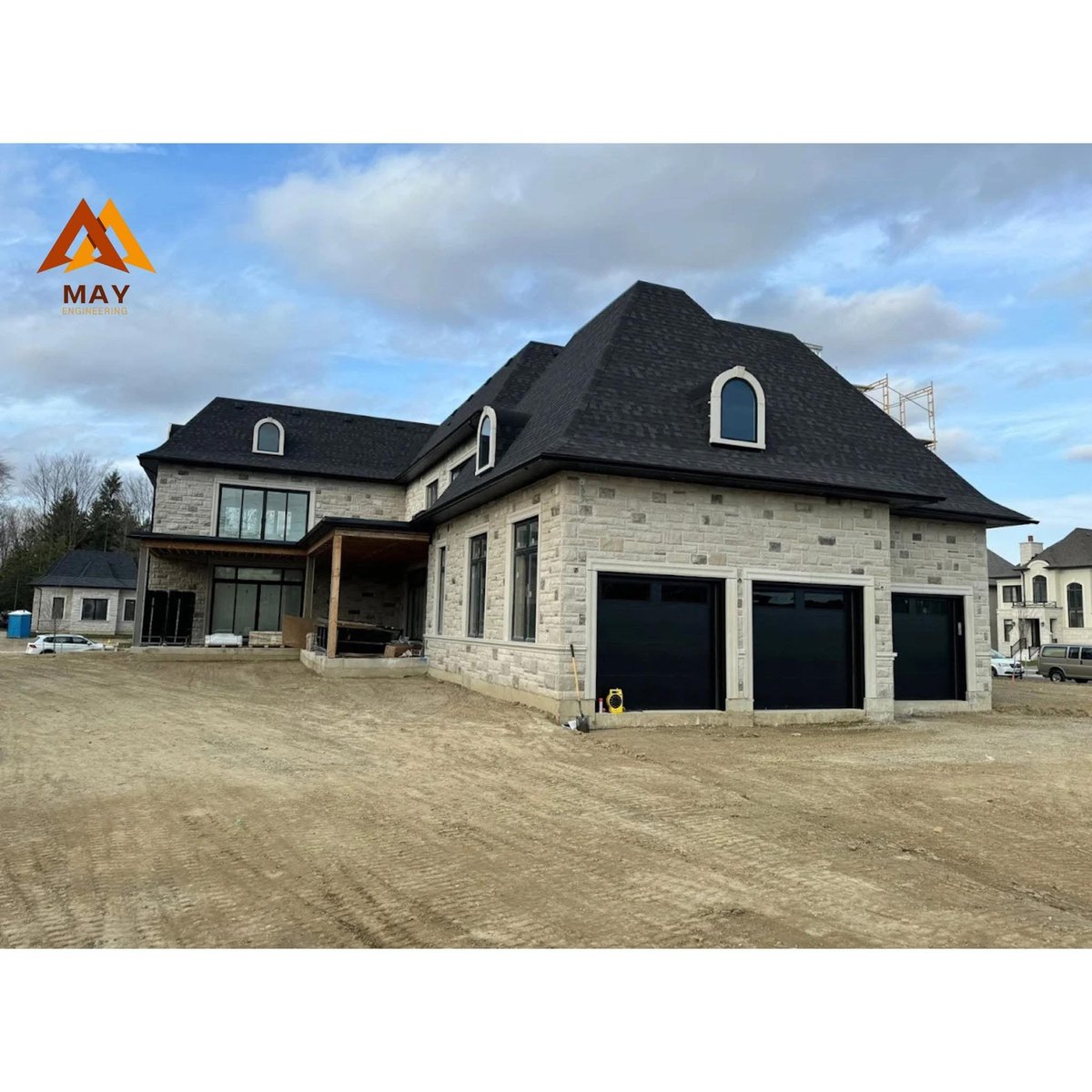 MAY Engineering Inc. engineering team Ontario — Custom Stone Home — 3-Car Garage